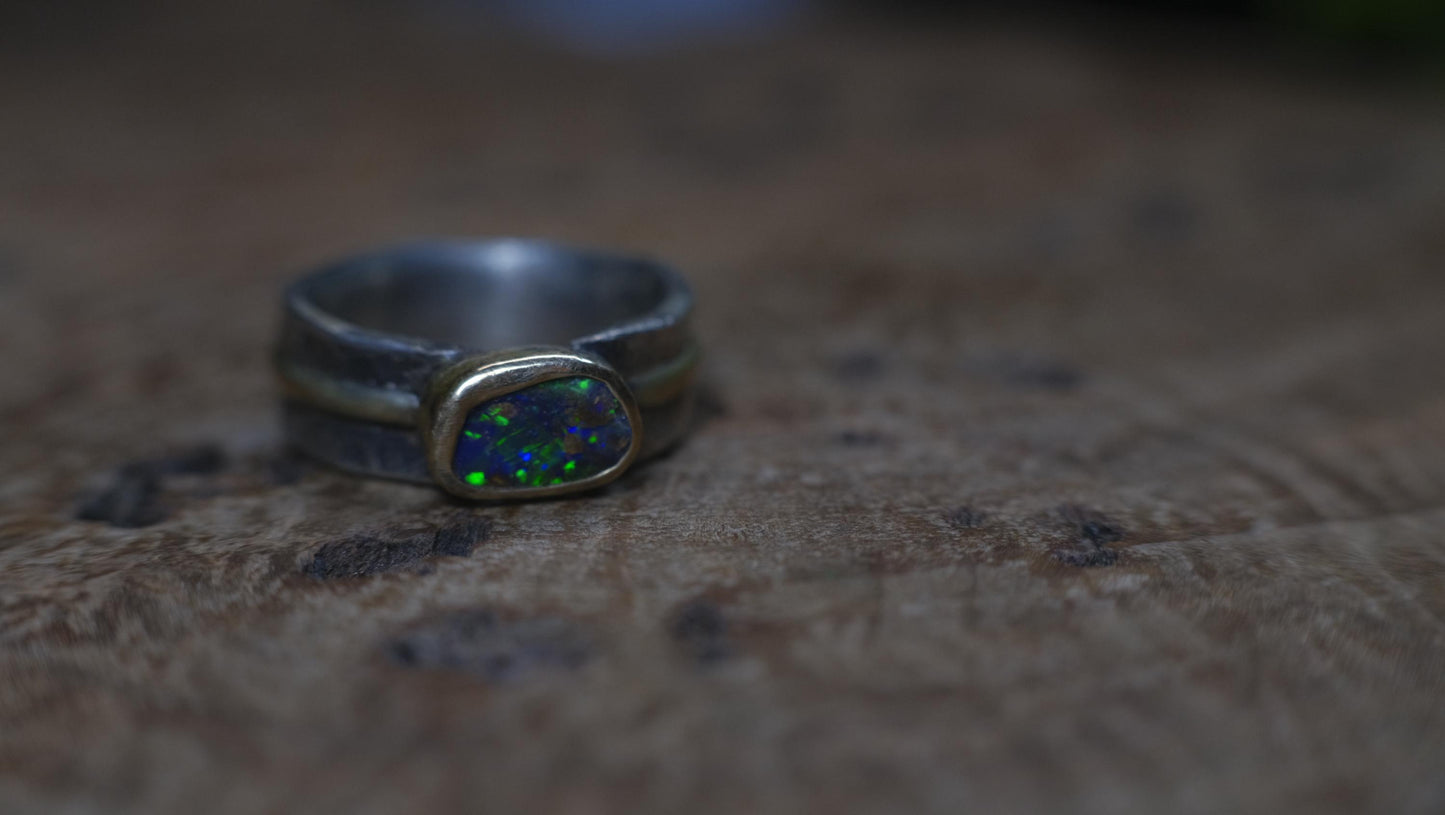 Dazzling boulder opal set in 9ct gold and on a unique textured sterling silver band with 9 ct gold detail