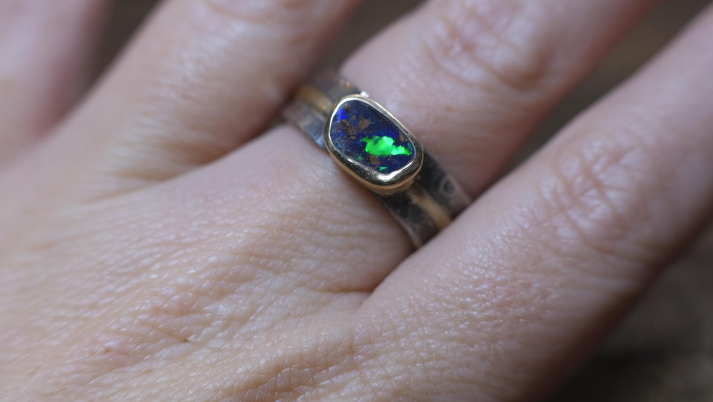Dazzling boulder opal set in 9ct gold and on a unique textured sterling silver band with 9 ct gold detail