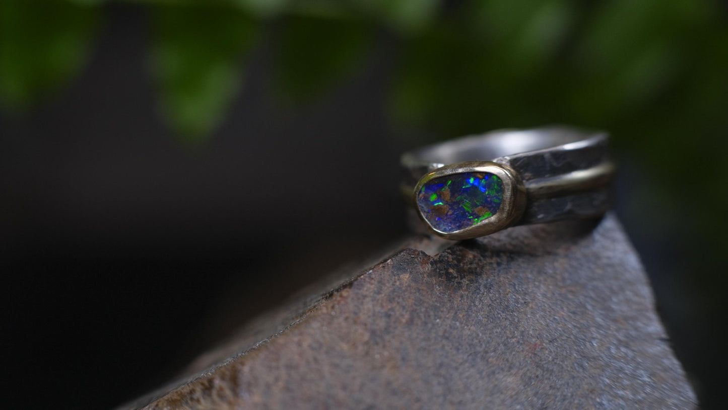 Dazzling boulder opal set in 9ct gold and on a unique textured sterling silver band with 9 ct gold detail