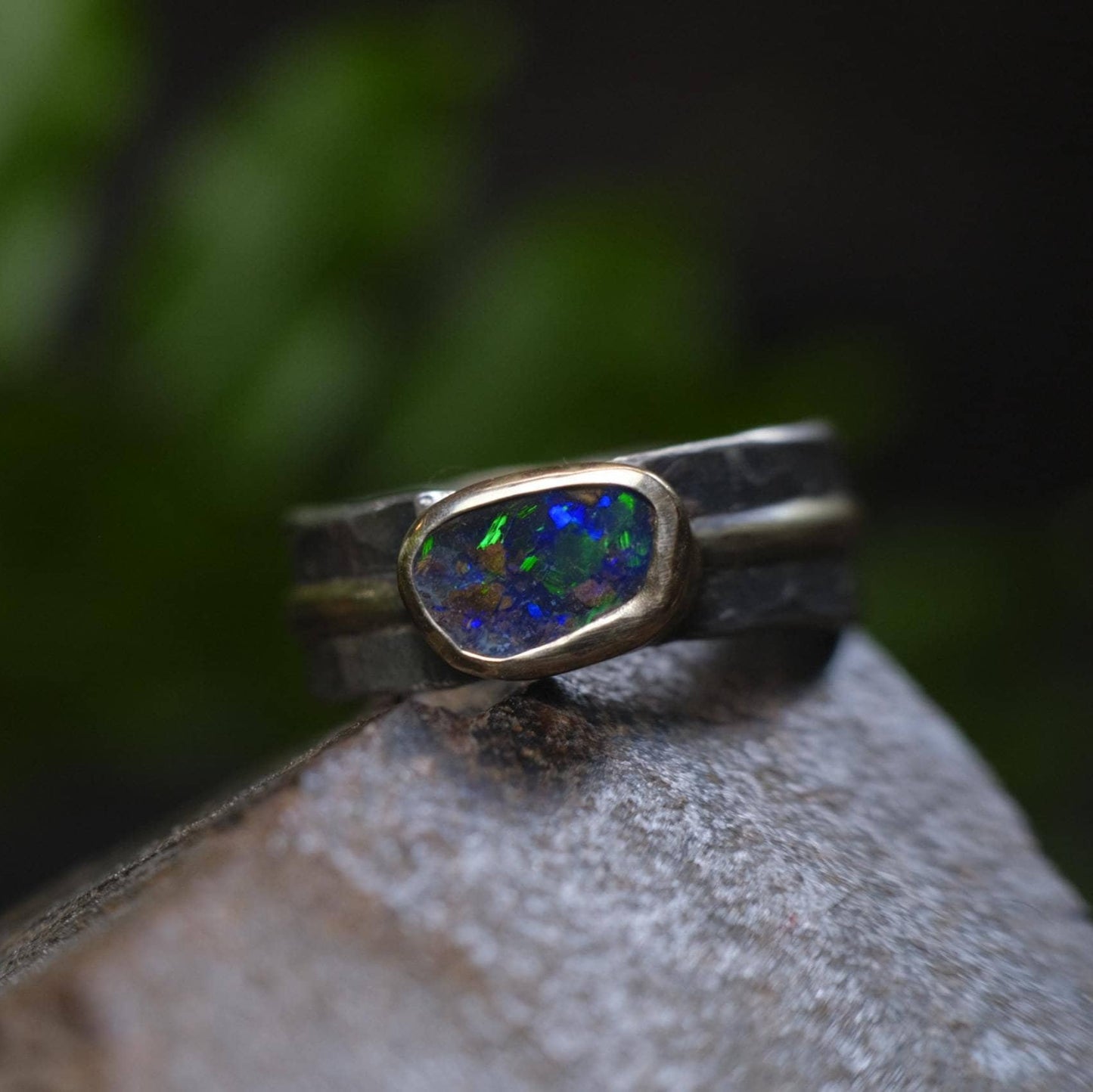 Dazzling boulder opal set in 9ct gold and on a unique textured sterling silver band with 9 ct gold detail