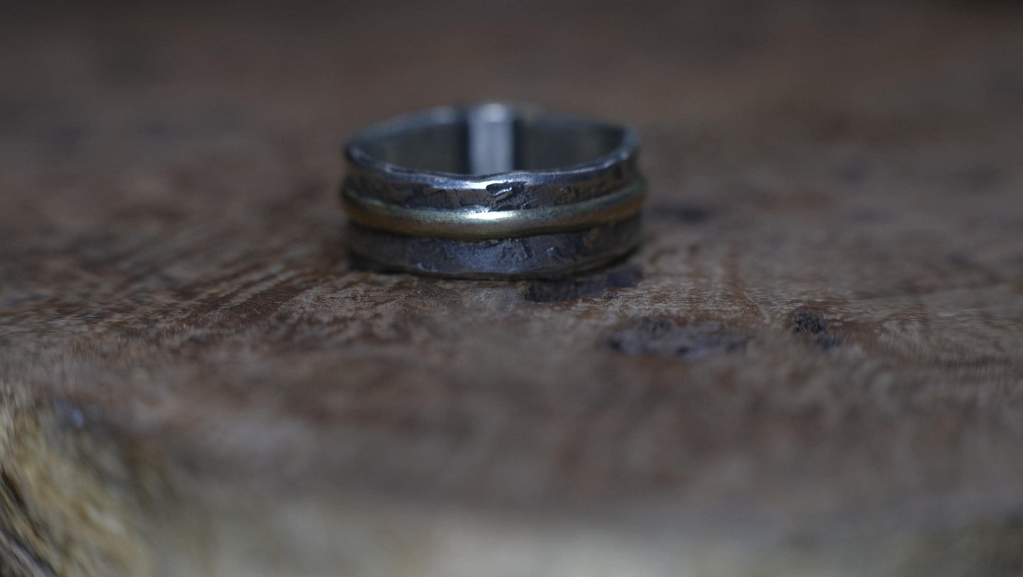 Dazzling boulder opal set in 9ct gold and on a unique textured sterling silver band with 9 ct gold detail