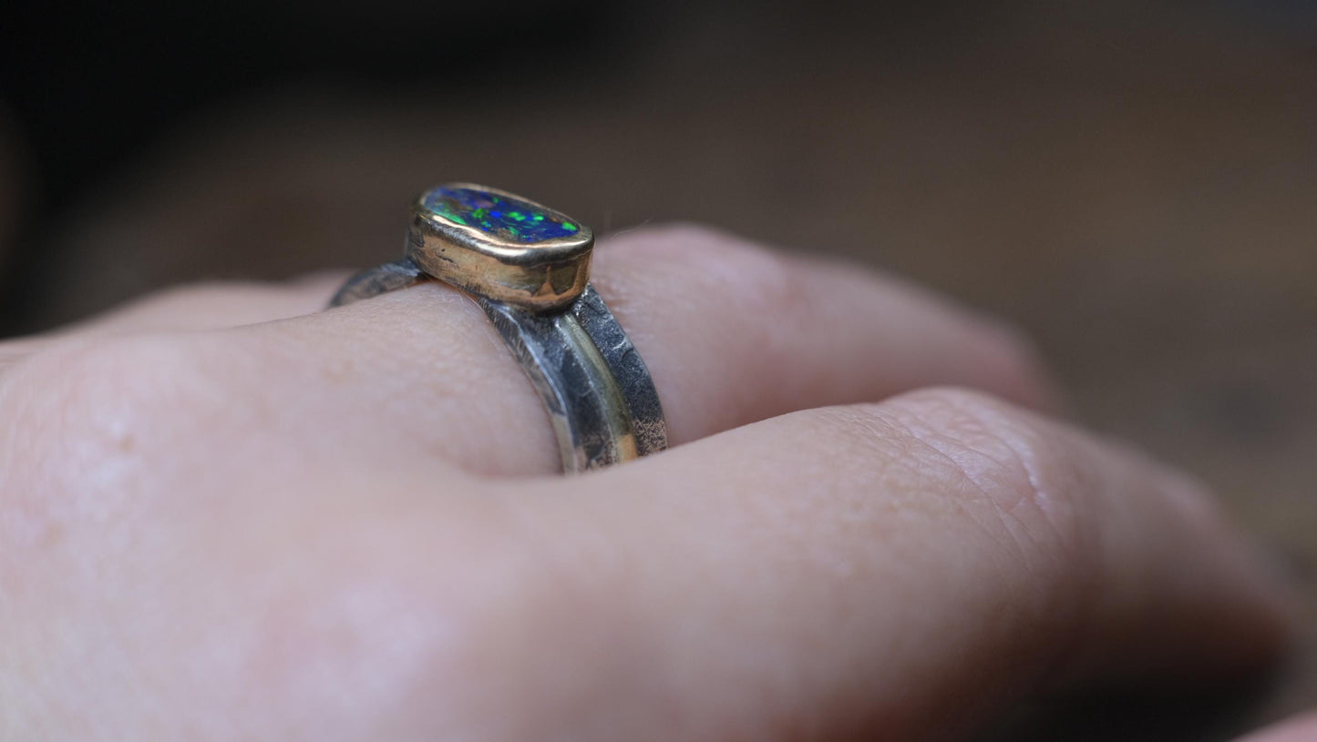 Dazzling boulder opal set in 9ct gold and on a unique textured sterling silver band with 9 ct gold detail