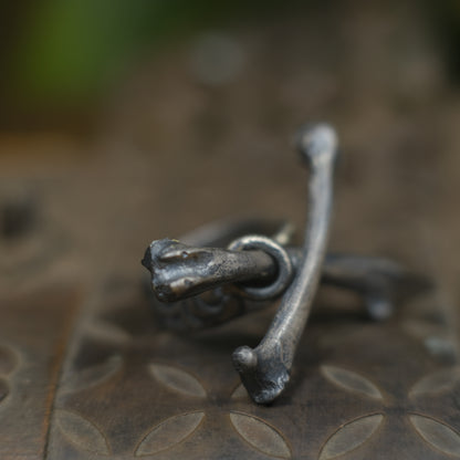Handmade sterling silver crossbones ring with rugged oxidised pirate-inspired texture