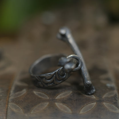 Handmade sterling silver crossbones ring with rugged oxidised pirate-inspired texture