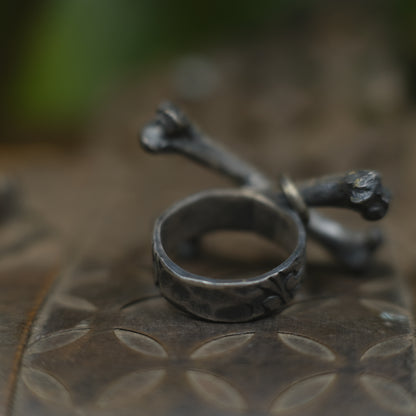 Handmade sterling silver crossbones ring with rugged oxidised pirate-inspired texture
