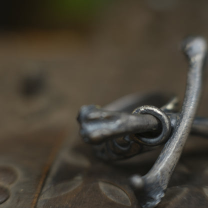 Handmade sterling silver crossbones ring with rugged oxidised pirate-inspired texture