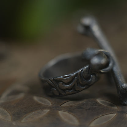Handmade sterling silver crossbones ring with rugged oxidised pirate-inspired texture