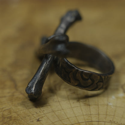 Handmade sterling silver crossbones ring with rugged oxidised pirate-inspired texture