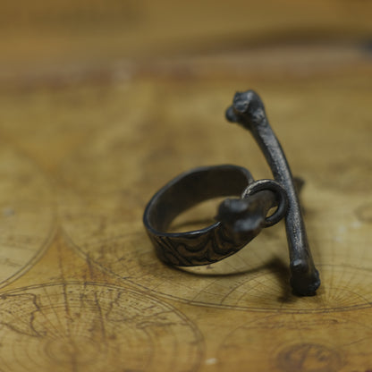 Handmade sterling silver crossbones ring with rugged oxidised pirate-inspired texture