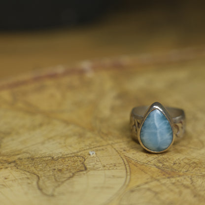 Larimar pirate ring with pale blue stone and textured oxidised sterling silver band