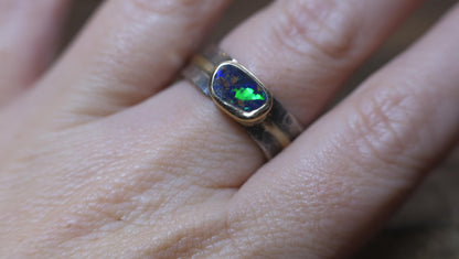 Blue green Australian boulder opal set in a 9ct gold bezel