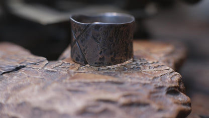 Rugged wide-band pirate-inspired sterling silver ring with oxidised hammered texture