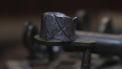 Rugged wide-band pirate-inspired sterling silver ring with oxidised hammered texture
