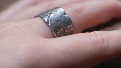 Rugged wide-band pirate-inspired sterling silver ring with oxidised hammered texture