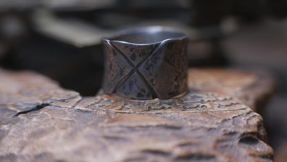 Rugged wide-band pirate-inspired sterling silver ring with oxidised hammered texture