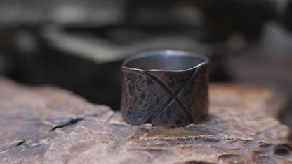Rugged wide-band pirate-inspired sterling silver ring with oxidised hammered texture