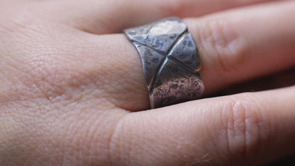 Rugged wide-band pirate-inspired sterling silver ring with oxidised hammered texture