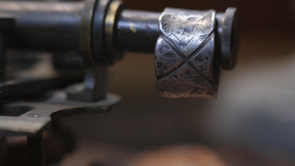 Rugged wide-band pirate-inspired sterling silver ring with oxidised hammered texture