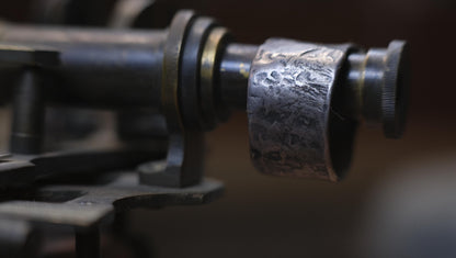 Rugged wide-band pirate-inspired sterling silver ring with oxidised hammered texture