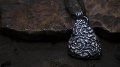 Handmade textured sterling silver pendant with oxidised finish on adjustable cord