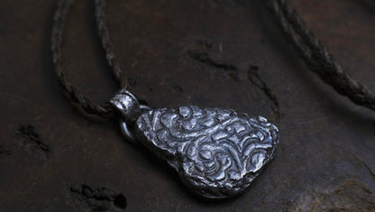 Handmade textured sterling silver pendant with oxidised finish on adjustable cord