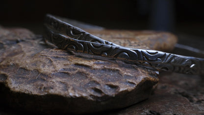 Pair of handmade interlocking sterling silver bangles with textured arabesque pattern