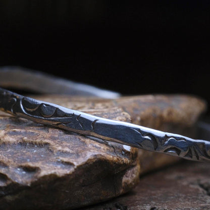 Handmade sterling silver bangle with textured Victorian-inspired arabesque pattern