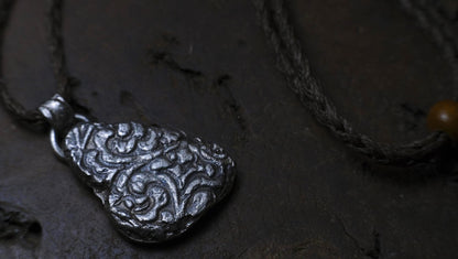 Handmade textured sterling silver pendant with oxidised finish on adjustable cord