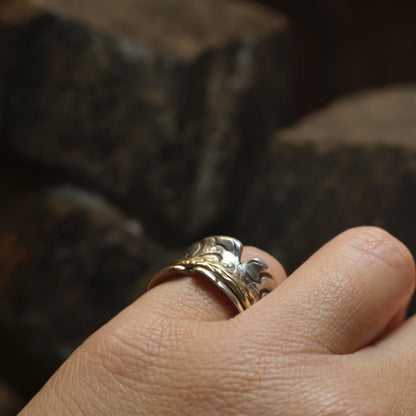 Handmade 9ct yellow gold spinner ring on a wide textured oxidised sterling silver band