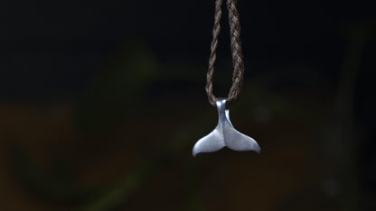 Handmade sterling silver whale tail talisman pendant on adjustable woven cord