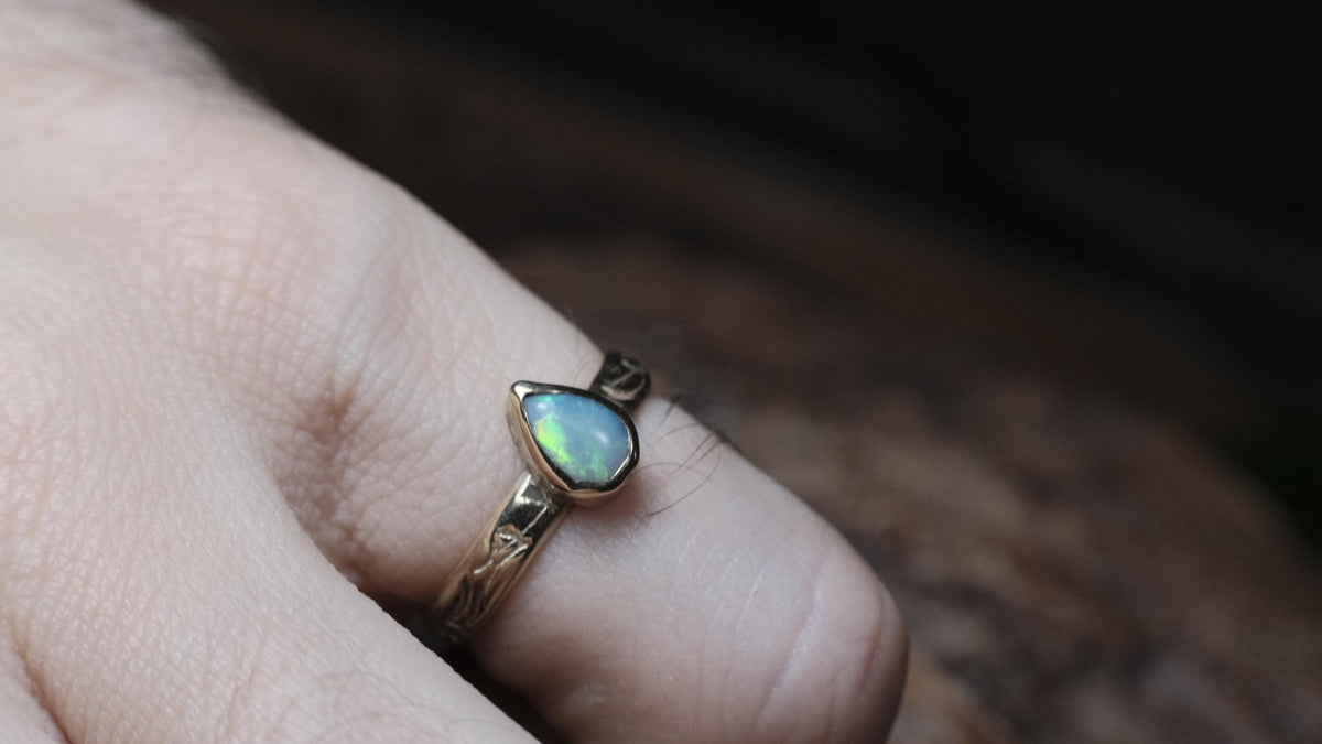 Lightning Ridge crystal opal gold ring worn on a finger