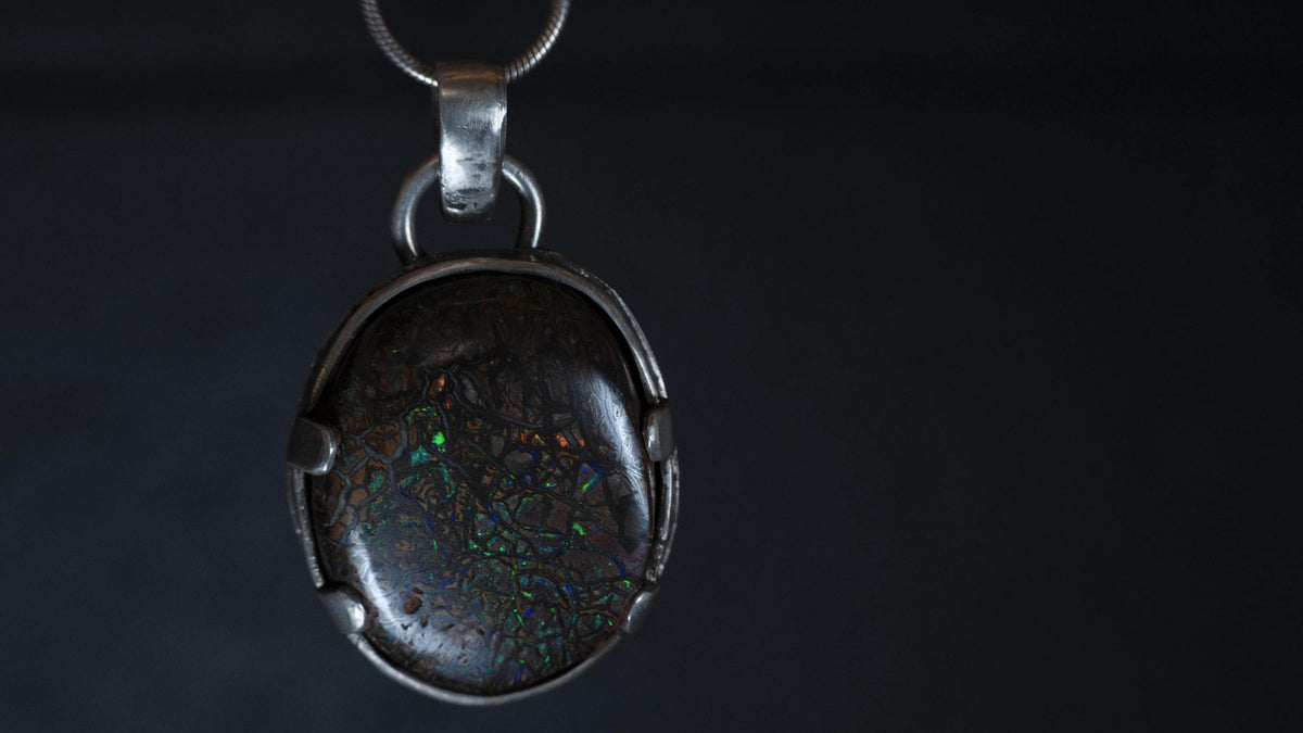 Close-up of Koroit matrix opal in sterling silver claws